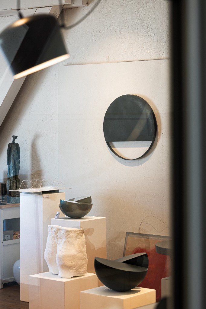 View into the studio — sculptures on pedestals against a white wall