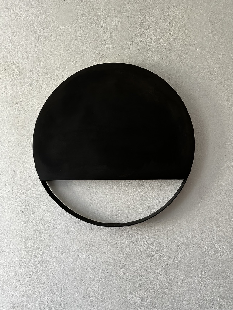 Wall object of black circle with open lower ring