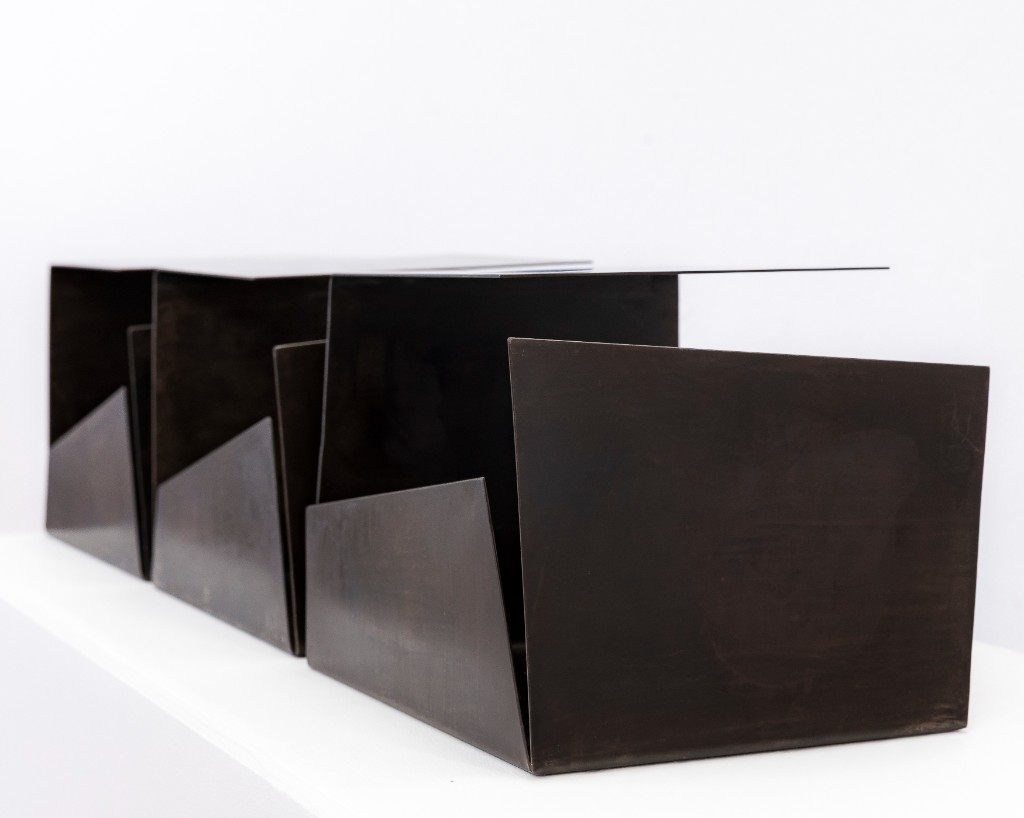 Three-part metal sculpture with sharp edges