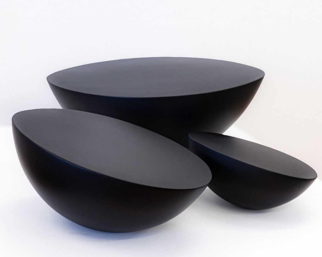 Three matte black hemispheres